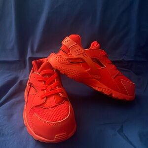 Red Nike child sneaker slip on child size 9 gently worn only a few times.